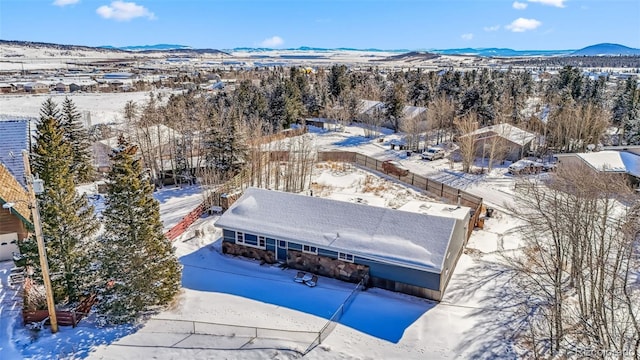 snowy aerial view with a mountain view