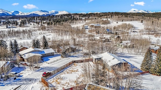 snowy aerial view featuring a mountain view