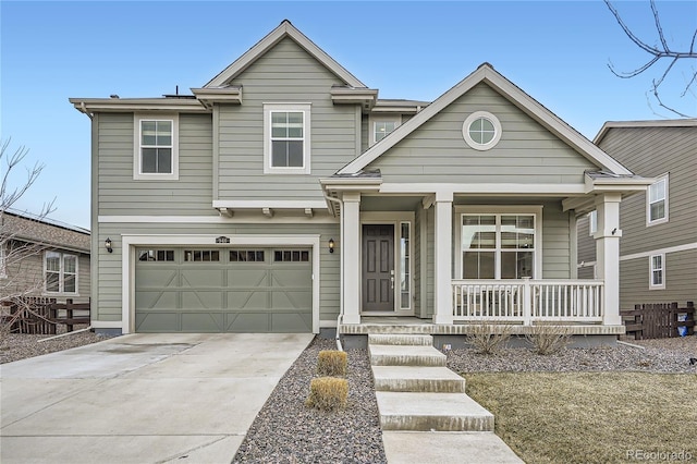 traditional home with a porch, a garage, and driveway