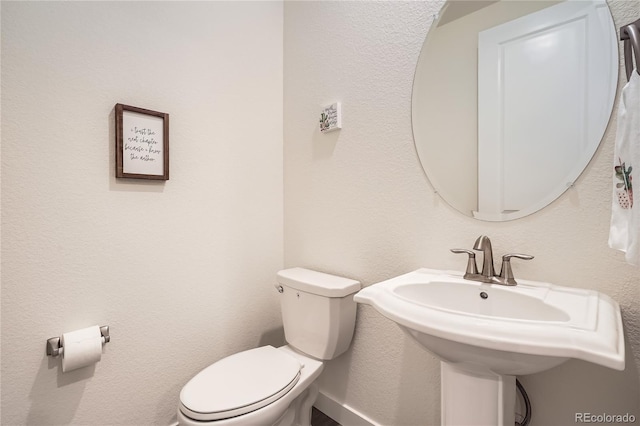 half bath featuring a sink and toilet