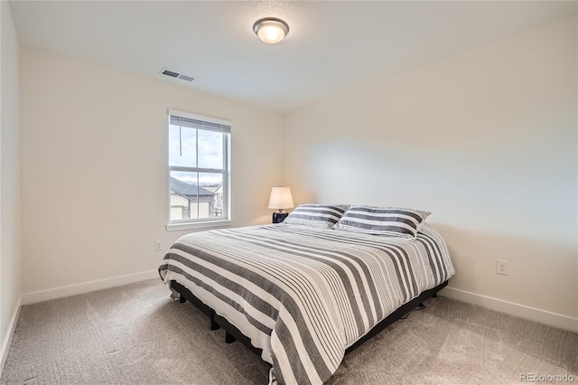 bedroom featuring carpet, visible vents, and baseboards