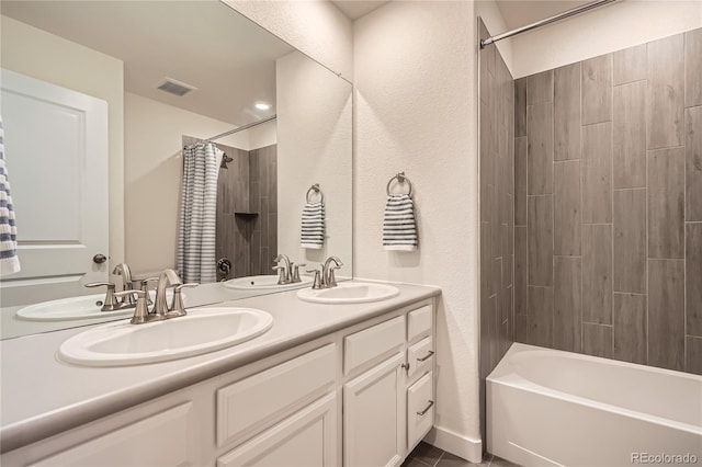 bathroom featuring shower / bath combination with curtain, visible vents, and a sink