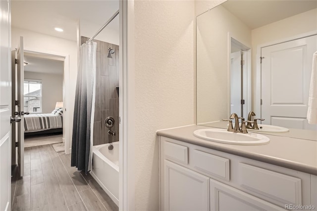 bathroom with ensuite bathroom, recessed lighting, vanity, and shower / bath combination with curtain