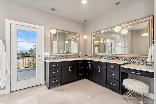 bathroom featuring vanity, backsplash, and tile patterned flooring