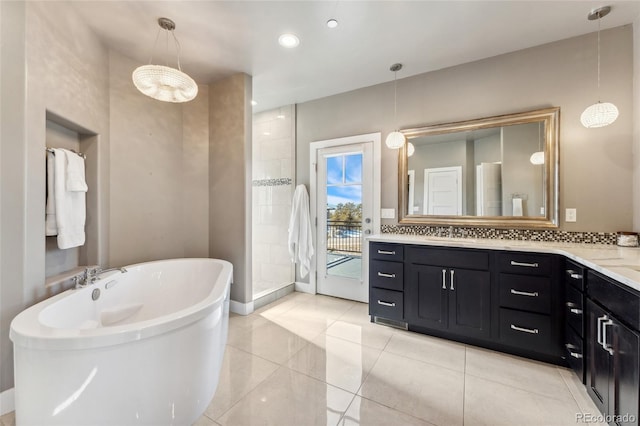 bathroom with tile patterned floors, vanity, and shower with separate bathtub