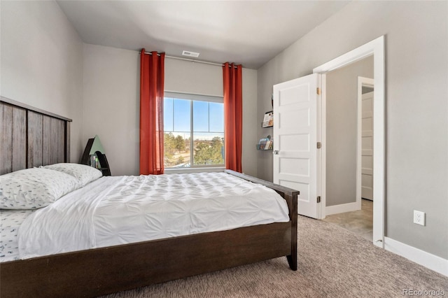 bedroom featuring light carpet