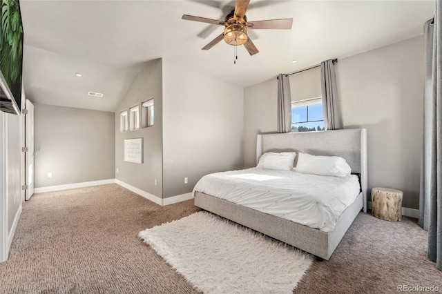 bedroom with ceiling fan, carpet flooring, and vaulted ceiling