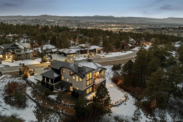 snowy aerial view with a mountain view