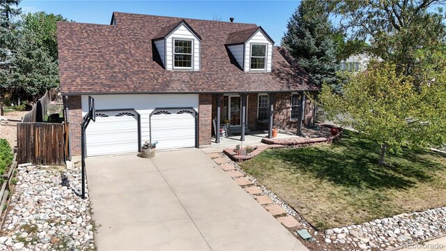 view of front of property with a garage and a front yard