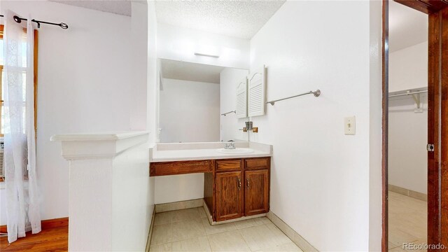 bathroom featuring a textured ceiling and vanity