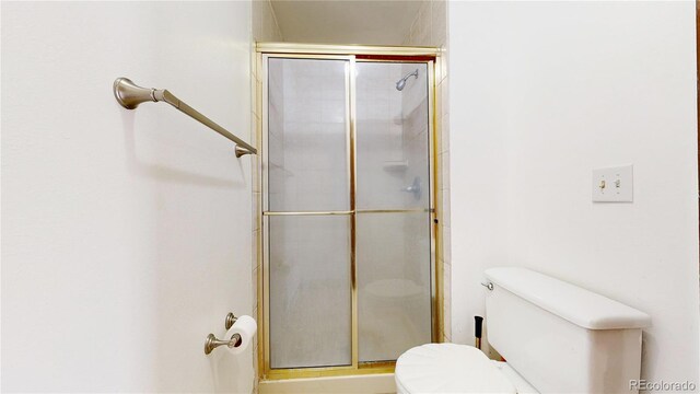 bathroom with toilet and walk in shower