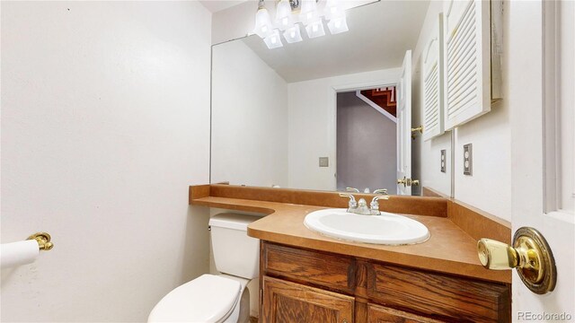 bathroom with toilet and vanity