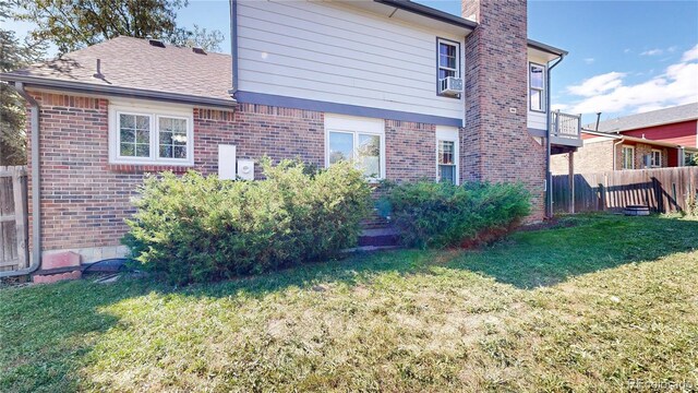 back of house featuring a yard