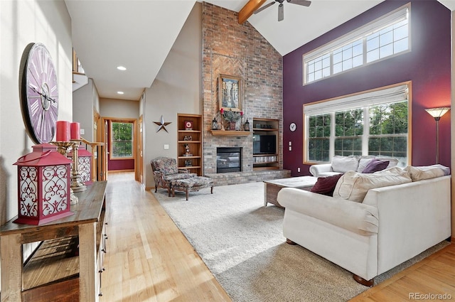 5683 Fig Way, Arvada, CO 80002 - living area with high vaulted ceiling, ceiling fan, a fireplace, beamed ceiling, and wood finished floors