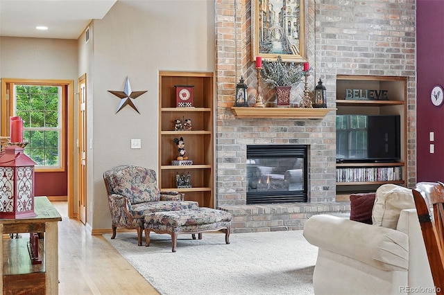 5683 Fig Way, Arvada, CO 80002 - living area with wood finished floors, a fireplace, and baseboards