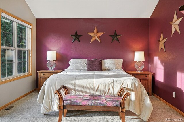 5683 Fig Way, Arvada, CO 80002 - bedroom with light colored carpet, lofted ceiling, baseboards, and an accent wall