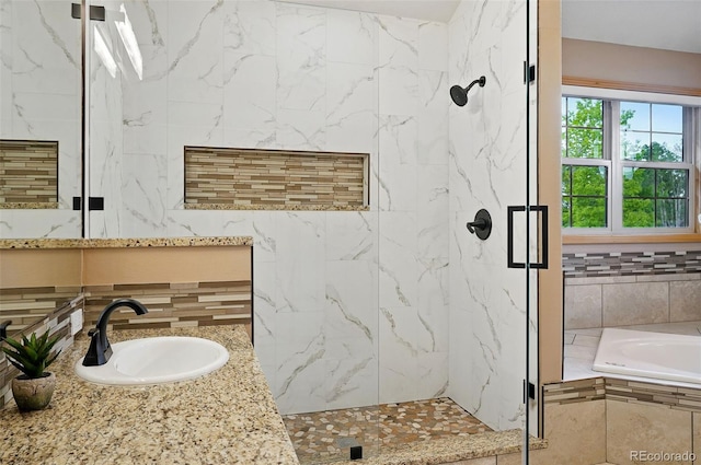 5683 Fig Way, Arvada, CO 80002 - bathroom with a marble finish shower, a garden tub, tasteful backsplash, and vanity