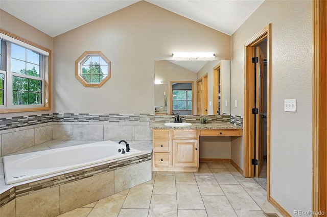 5683 Fig Way, Arvada, CO 80002 - bathroom with lofted ceiling, vanity, a bath, healthy amount of natural light, and tile patterned flooring