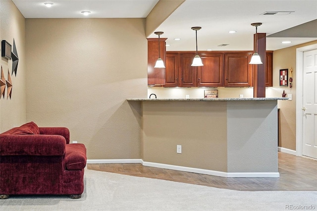 5683 Fig Way, Arvada, CO 80002 - kitchen featuring baseboards, pendant lighting, light stone counters, light carpet, and recessed lighting