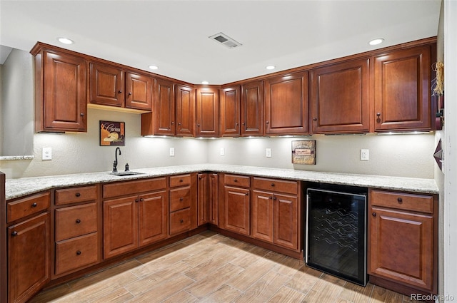 5683 Fig Way, Arvada, CO 80002 - kitchen featuring beverage cooler, a sink, recessed lighting, light wood-style flooring, and light stone countertops