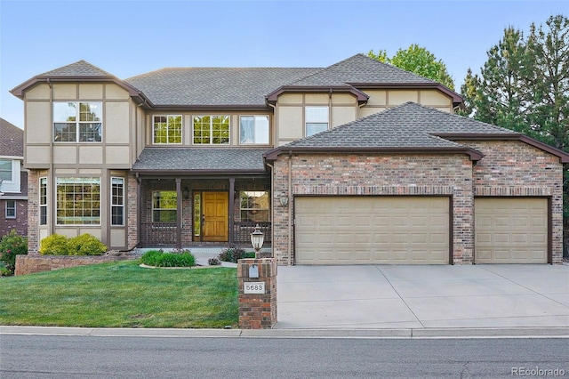 5683 Fig Way, Arvada, CO 80002 - view of front of property with an attached garage, concrete driveway, a front yard, and stucco siding