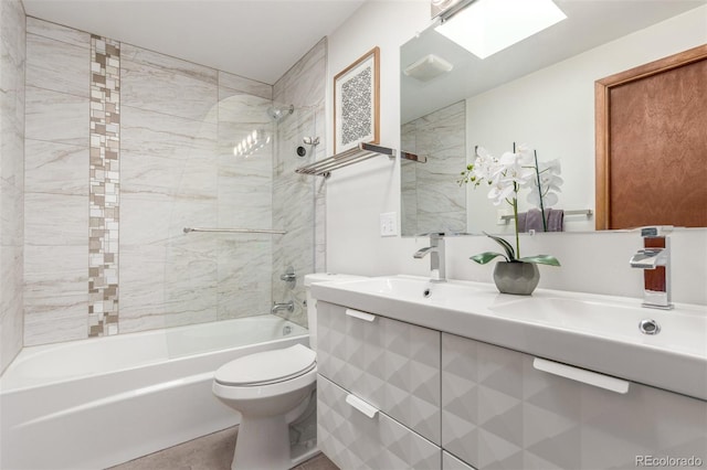 bathroom with toilet, shower / bath combination, double vanity, a skylight, and a sink