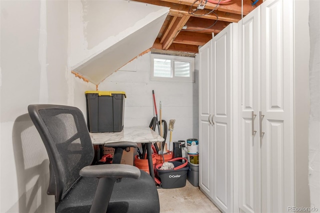 home office with unfinished concrete flooring