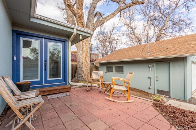 view of patio with french doors and fence