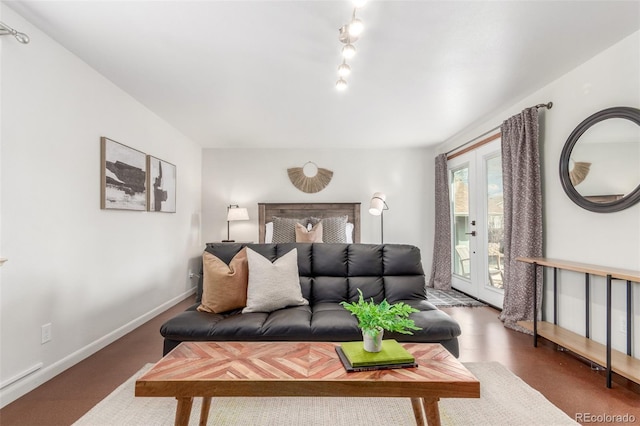 living room featuring baseboards and track lighting
