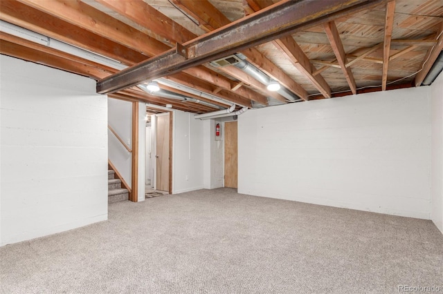basement with stairway and carpet flooring