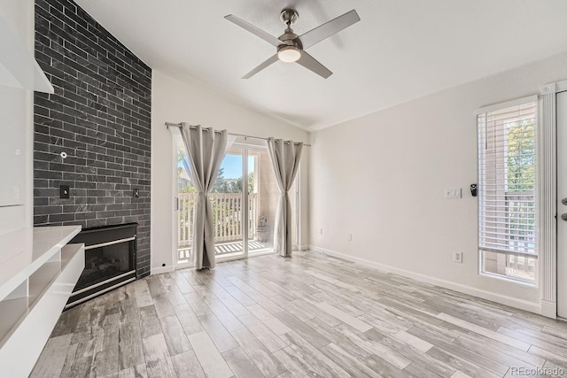 unfurnished living room featuring plenty of natural light, light hardwood / wood-style floors, and lofted ceiling