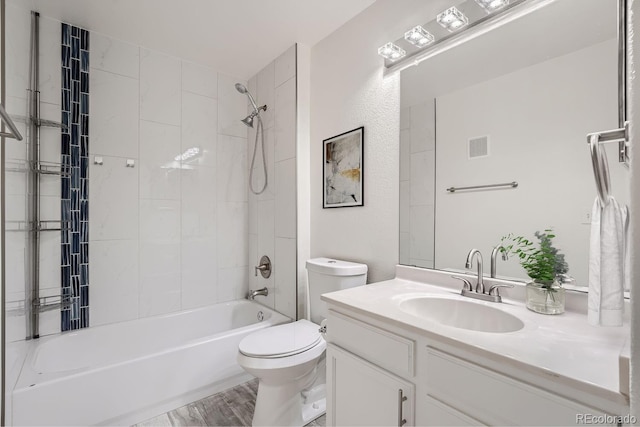 bathroom featuring bathtub / shower combination, visible vents, toilet, vanity, and wood finished floors