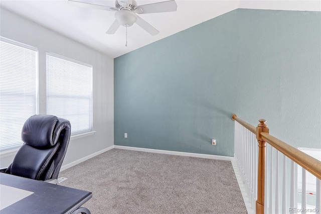 home office with lofted ceiling, baseboards, a ceiling fan, and light colored carpet