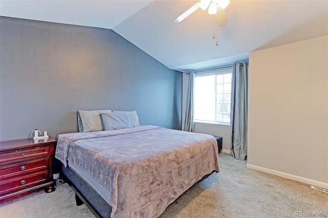 bedroom featuring lofted ceiling, ceiling fan, light carpet, and baseboards