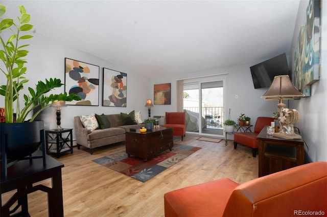 living room with vaulted ceiling and light wood finished floors