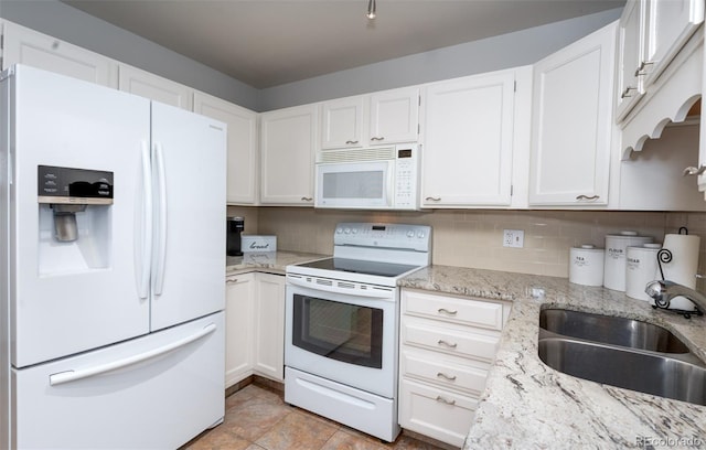 kitchen with white cabinets, white appliances, backsplash, and a sink