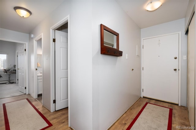 corridor featuring light wood-style floors