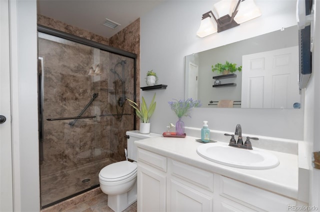 bathroom featuring toilet, a shower stall, visible vents, and vanity