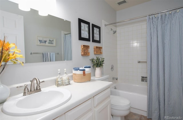 bathroom featuring toilet, visible vents, shower / bath combo with shower curtain, and vanity