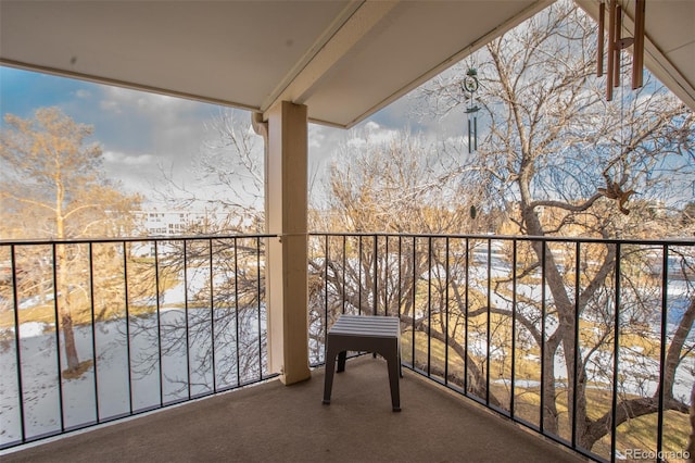 view of snow covered back of property