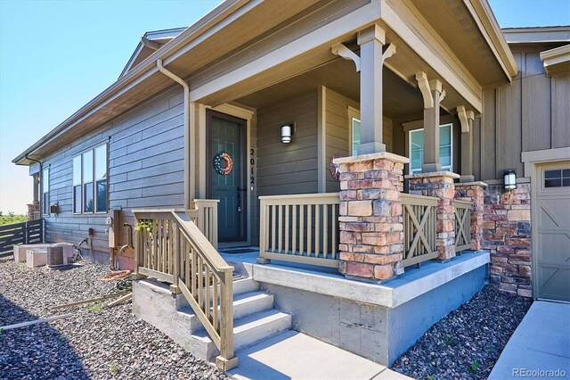 2012 Sagerock Dr, Castle Pines, CO 80108 - entrance to property featuring a porch and board and batten siding