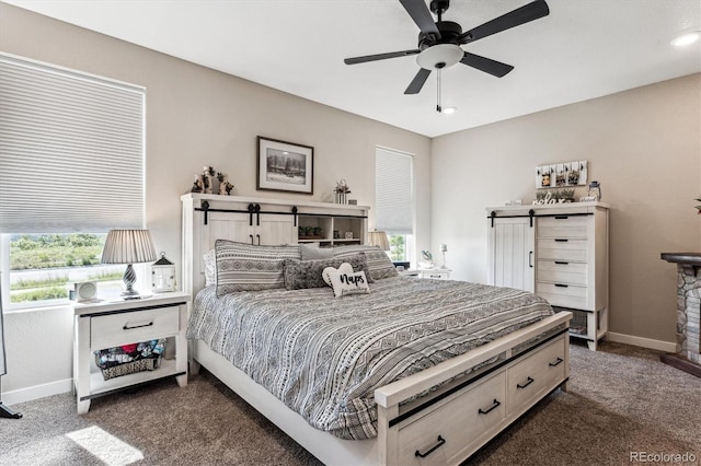 2012 Sagerock Dr, Castle Pines, CO 80108 - carpeted bedroom featuring a ceiling fan and a stone fireplace