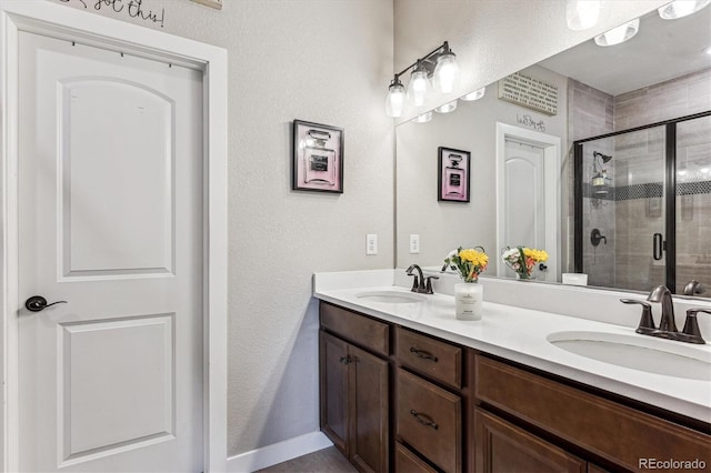 2012 Sagerock Dr, Castle Pines, CO 80108 - full bath featuring double vanity, a stall shower, and a textured wall
