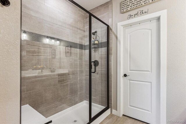 2012 Sagerock Dr, Castle Pines, CO 80108 - bathroom featuring a shower stall and wood finished floors