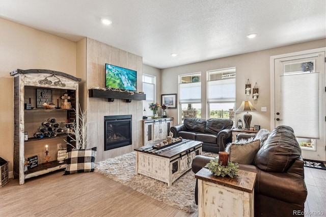 2012 Sagerock Dr, Castle Pines, CO 80108 - living area featuring wood finished floors, a fireplace, and recessed lighting