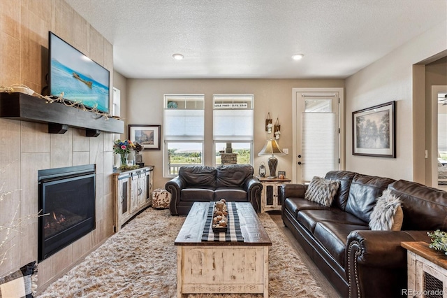 2012 Sagerock Dr, Castle Pines, CO 80108 - living area with healthy amount of natural light, a fireplace, a textured ceiling, carpet flooring, and recessed lighting