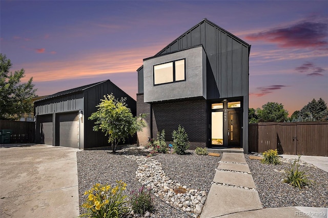 3057 S University Cir, Englewood, CO 80113 - contemporary home featuring board and batten siding, an outbuilding, a garage, and concrete driveway