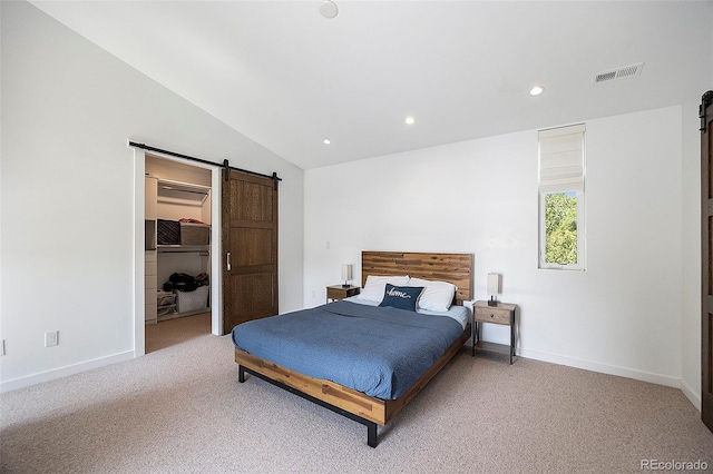 3057 S University Cir, Englewood, CO 80113 - bedroom with a barn door, carpet flooring, lofted ceiling, a walk in closet, and recessed lighting