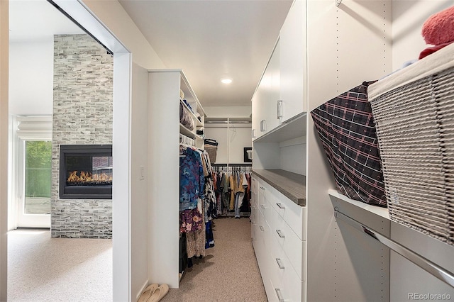 3057 S University Cir, Englewood, CO 80113 - walk in closet featuring light carpet and a tiled fireplace