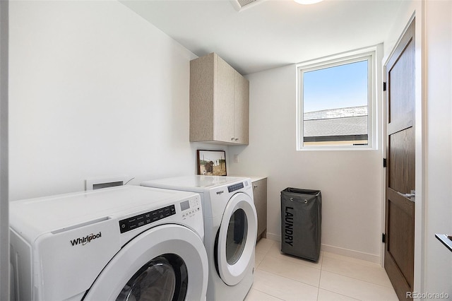 3057 S University Cir, Englewood, CO 80113 - laundry room with cabinet space, washing machine and clothes dryer, and light tile patterned flooring